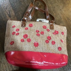 pink and weaved purse with brown straps